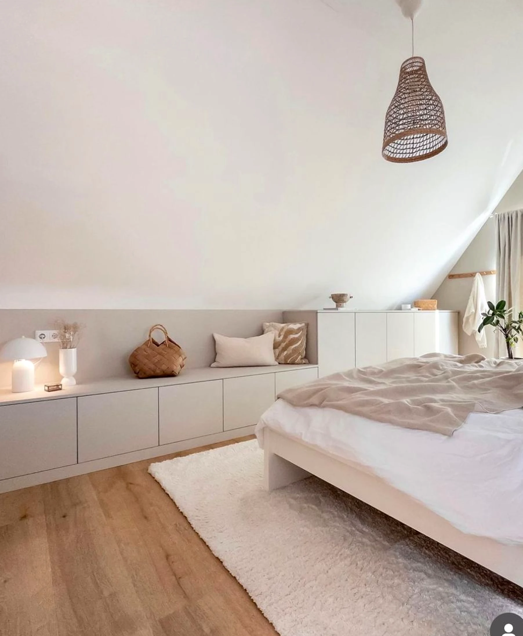 Soft neutral bedroom frames the wall with light, making the scene feel ready for quiet use.